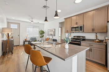 A kitchen with a table and chairs.